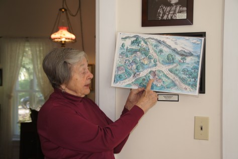 Docent Kathryn Hansen shows a Lois Lenski illustration of the Betsy-Tacy books and compares it to the neighborhood today.
